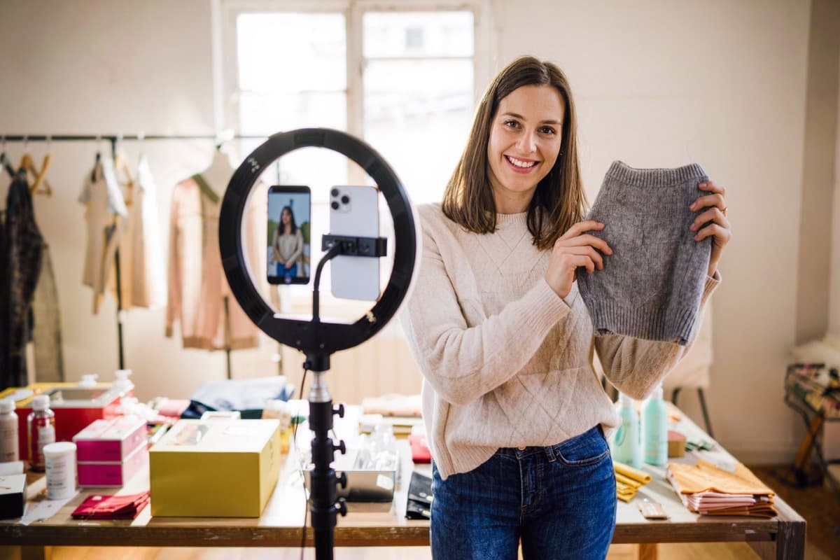 A seller filming a product video for social media in her home studio